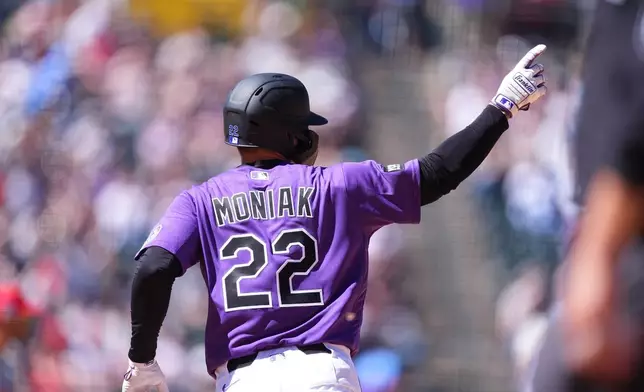 Colorado Rockies' Mickey Moniak gestures to the bullpen as he circles the bases after hitting a solo home run off Philadelphia Phillies starting pitcher Taijuan Walker in the fifth inning of a baseball game Sunday, April 5, 2026, in Denver. (AP Photo/David Zalubowski)