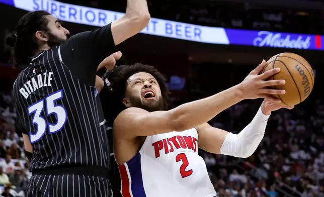 Detroit Pistons guard Cade Cunningham (2) goes to the basket against Orlando Magic center Goga Bitadze (35) during the first half in Game 1 of a first-round NBA basketball playoffs series Sunday, April 19, 2026, in Detroit. (AP Photo/Duane Burleson)
