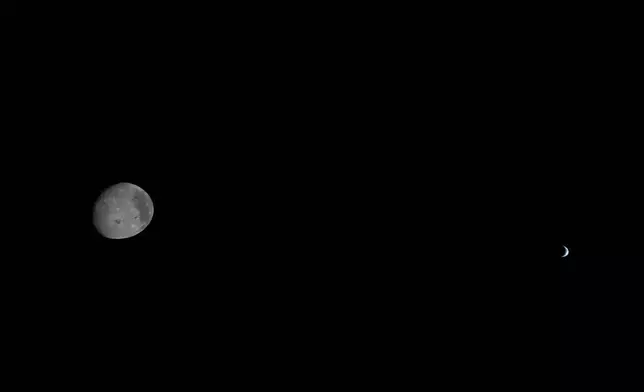 This image provided by NASA, the Artemis II crew captured this view the Moon and Earth are shown on Monday, April 6, 2026. (NASA via AP)