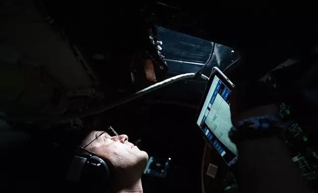 This image provided by NASA, astronaut and Artemis II Commander Reid Wiseman takes a moment during the seven-hour lunar observation period where the crew reported to the ground team their observations including color nuances, which will help enhance scientific understandings of the Moon on Monday, April 6, 2026. (NASA via AP)