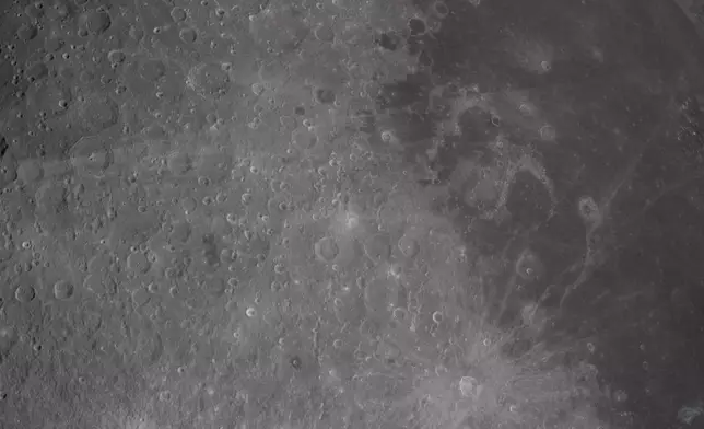 In this image provided by NASA, the Artemis II crew captured this image of the of Carroll Crater, a name suggested by the crew for Reid Wiseman late wife Carroll Taylor Wiseman on Monday, April 6, 2026. (NASA via AP)