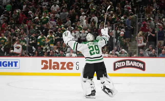 Dallas Stars goaltender Jake Oettinger (29) celebrates after the double overtime win against the Minnesota Wild of Game 3 in the first round of the NHL Stanley Cup hockey playoffs early morning Thursday, April 23, 2026, in St. Paul, Minn. (AP Photo/Abbie Parr)