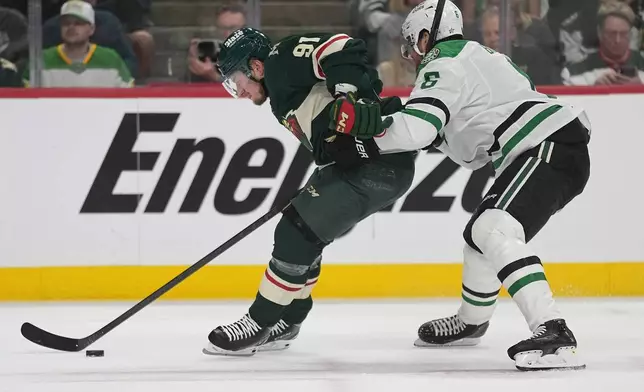 Minnesota Wild right wing Vladimir Tarasenko (91) skates with the puck as Dallas Stars defenseman Lian Bichsel (6) defends during the first period of Game 3 in the first-round of the NHL Stanley Cup hockey playoffs Wednesday, April 22, 2026, in St. Paul, Minn. (AP Photo/Abbie Parr)