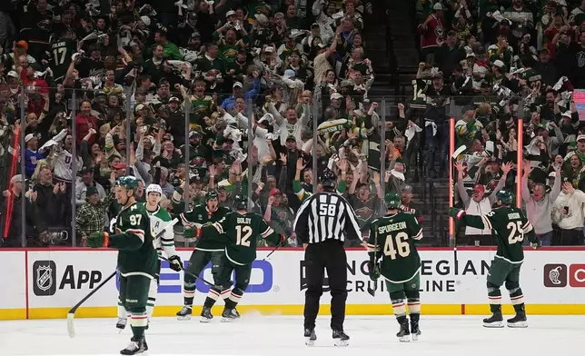 Minnesota Wild center Michael McCarron (47), back, left, celebrates after scoring a goal during the second period of Game 3 in the first round of the NHL Stanley Cup hockey playoffs against the Dallas Stars Wednesday, April 22, 2026, in St. Paul, Minn. (AP Photo/Abbie Parr)