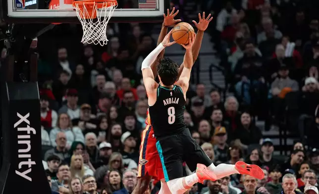 Portland Trail Blazers forward Deni Avdija (8) goes to the basket as Portland Trail Blazers new owner Tom Dundon, second from right, watches during the first half of an NBA basketball game against the New Orleans Pelicans, Thursday, April 2, 2026, in Portland, Ore. (AP Photo/Jenny Kane)