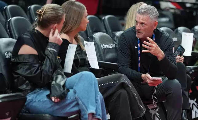 Portland Trail Blazers new owner Tom Dundon, right is seated before an NBA basketball game against the New Orleans Pelicans, Thursday, April 2, 2026, in Portland, Ore. (AP Photo/Jenny Kane)