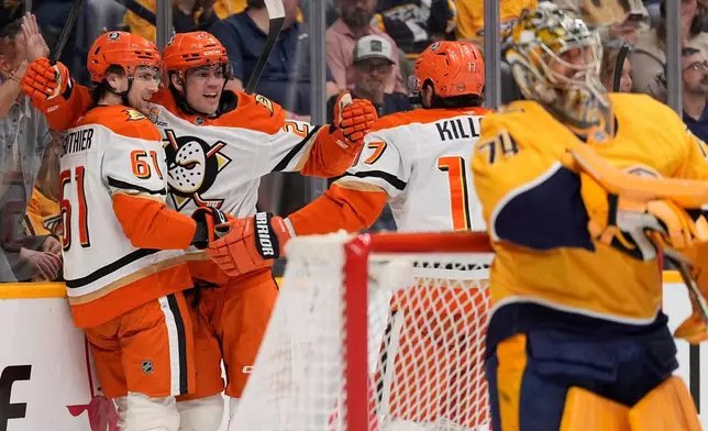 Anaheim Ducks left wing Cutter Gauthier (61) celebrates his goal with center Ryan Poehling (25) and left wing Alex Killorn (17) during the first period of an NHL hockey game against the Nashville Predators, Thursday, April 16, 2026, in Nashville, Tenn. (AP Photo/George Walker IV)
