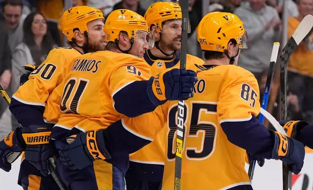 Nashville Predators center Steven Stamkos (91) celebrates his goal with teammates during the second period of an NHL hockey game against the Anaheim Ducks, Thursday, April 16, 2026, in Nashville, Tenn. (AP Photo/George Walker IV)