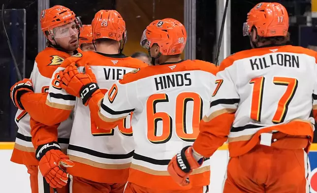 Anaheim Ducks left wing Cutter Gauthier, left, celebrates his goal with teammates during the third period of an NHL hockey game against the Nashville Predators, Thursday, April 16, 2026, in Nashville, Tenn. (AP Photo/George Walker IV)