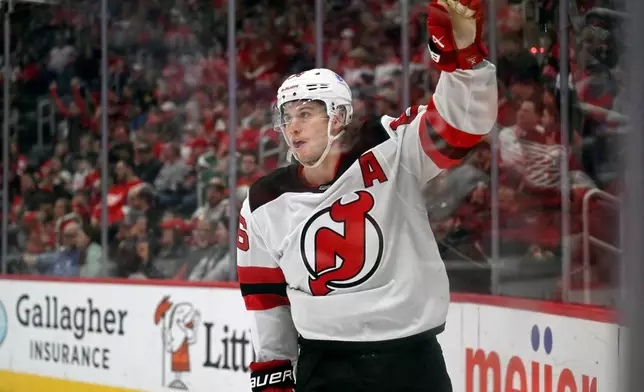 New Jersey Devils center Jack Hughes reacts after scoring during the first period of an NHL hockey game against the Detroit Red Wings, Saturday, April 11, 2026, in Detroit. (AP Photo/Jose Juarez)