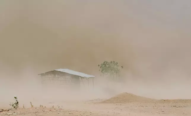 Dust engulfs a home and a tree that are barely visible amid a drought on Friday, Jan. 9, 2026, in Sanqotor, Ethiopia. (AP Photo/Julianne Gauron)
