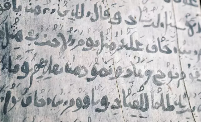 An example of text from the Quran, written on a wooden tablet with myrrh ink, is displayed Thursday Jan. 8, 2026, in Sanqotor, Ethiopia. (AP Photo/Julianne Gauron)