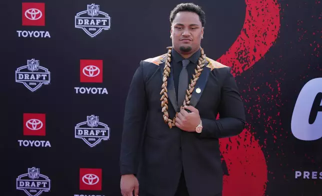 Miami offensive lineman Francis Mauigoa poses on the red carpet before the first round of the NFL football draft, Thursday, April 23, 2026, in Pittsburgh. (AP Photo/Gene J. Puskar)