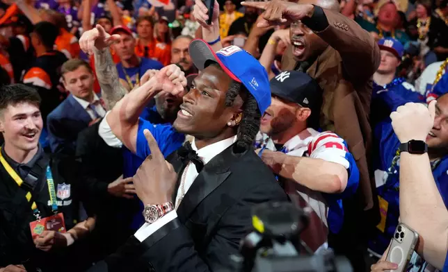 Ohio State linebacker Arvell Reese celebrates with fans after being chosen by the New York Giants with the fifth overall pick during the first round of the NFL football draft, Thursday, April 23, 2026, in Pittsburgh. (AP Photo/Sue Ogrocki)