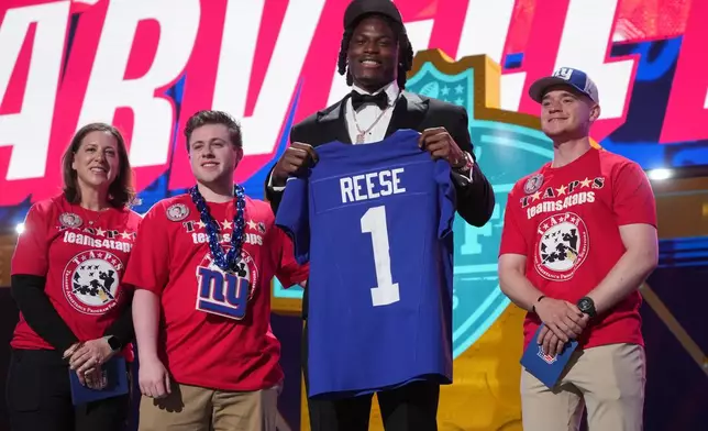 Ohio State linebacker Arvell Reese poses with a jersey after being chosen by the New York Giants with the fifth overall pick during the first round of the NFL football draft, Thursday, April 23, 2026, in Pittsburgh. (AP Photo/Gene J. Puskar)
