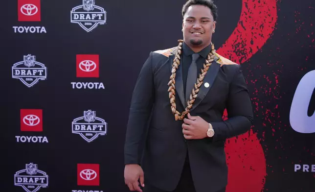 Miami offensive lineman Francis Mauigoa poses on the red carpet before the first round of the NFL football draft, Thursday, April 23, 2026, in Pittsburgh. (AP Photo/Gene J. Puskar)