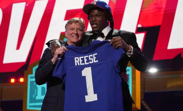 Ohio State linebacker Arvell Reese poses with NFL Commissioner Roger Goodell after being chosen by the New York Giants with the fifth overall pick during the first round of the NFL football draft, Thursday, April 23, 2026, in Pittsburgh. (AP Photo/Gene J. Puskar)
