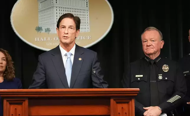 Los Angeles district attorney Nathan Hochman answers questions next to police chief Jim McDonnell Monday, April 20, 2026, in Los Angeles regarding the case of singer D4vd, who was charged on suspicion of killing a 14-year-old girl whose dismembered body was found in his car. (AP Photo/Damian Dovarganes)