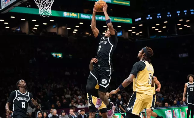 Brooklyn Nets forward E.J. Liddell (9) goes for a dunk during the first half of an NBA basketball game against the Washington Wizards, Sunday, April 5, 2026, in New York. (AP Photo/Angelina Katsanis)