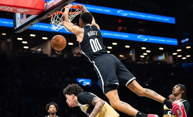 Brooklyn Nets forward Josh Minott (00) dunks during the first half of an NBA basketball game against the Washington Wizards, Sunday, April 5, 2026, in New York. (AP Photo/Angelina Katsanis)