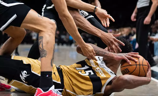 Washington Wizards forward Julian "Juju" Reese (15) fights to keep hold of the ball during the second half of an NBA basketball game against the Brooklyn Nets, Sunday, April 5, 2026, in New York. (AP Photo/Angelina Katsanis)