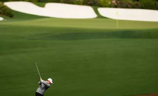 Rory McIlroy, of Northern Ireland, hits from the fairway on the 13th hole during a practice round ahead of the Masters golf tournament at the Augusta National Golf Club, Tuesday, April 7, 2026, in Augusta, Ga. (AP Photo/David J. Phillip)