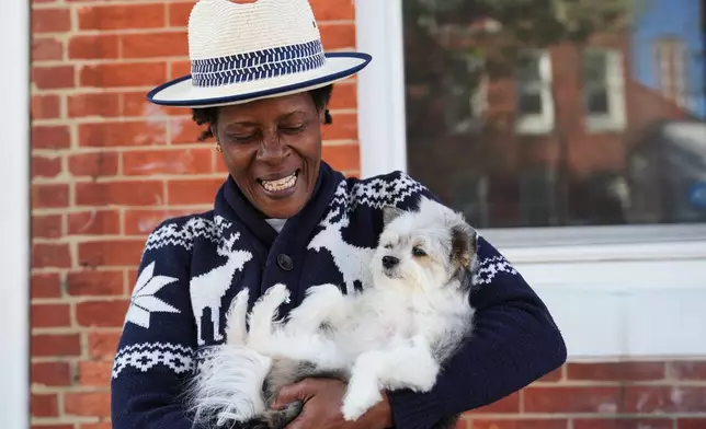 Jevona Anderson, a student at the University of Baltimore, poses for a portrait with her dog, Bella, Tuesday, April 7, 2026, in Baltimore. (AP Photo/Stephanie Scarbrough)