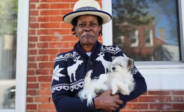Jevona Anderson, a student at the University of Baltimore, poses for a portrait with her dog, Bella, Tuesday, April 7, 2026, in Baltimore. (AP Photo/Stephanie Scarbrough)