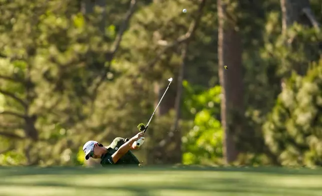 Min Woo Lee, of Australia, hits from the fairway on the 17th hole during the first round of the Masters golf tournament at the Augusta National Golf Club, Thursday, April 9, 2026, in Augusta, Ga. (AP Photo/Gerald Herbert)
