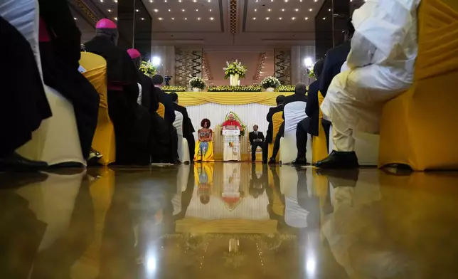 Pope Leo XIV, background center, flanked by Cameroon's President Paul Biya and his wife Chantal, meets with the authorities, civil society and the diplomatic corps in Yaounde Cameroon, Wednesday, April 15, 2026. (AP Photo/Andrew Medichini)