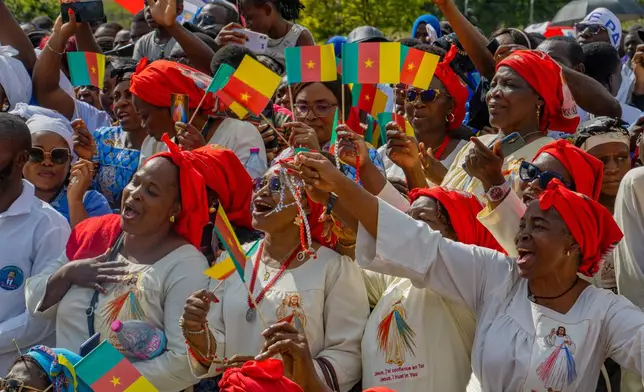 People cheer as Pope Leo XIV arrives in Yaounde, Cameroon, Wednesday, April 15, 2026. (AP Photo/Welba Yamo Pascal)