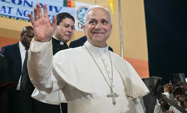 Pope Leo XIV waves to supporters as he leaves after his visit to the Ngul Zamba (Power of God) orphanage in Yaounde, Cameroon, Wednesday April 15, 2026 on the third day of his apostolic journey to Africa. (Alberto Pizzoli, Pool Photo via AP)