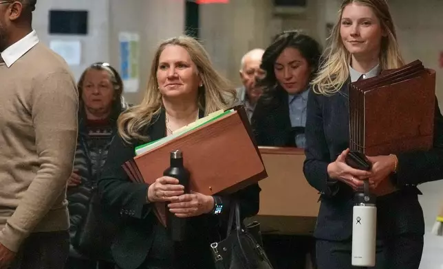 Assistant District Attorney Nicole Blumberg, center, arrives for the first day of Harvey Weinstein's third trial, in criminal court in New York, Tuesday, April 21, 2026. (AP Photo/Richard Drew)