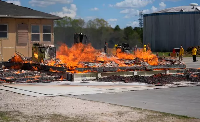 An accessory dwelling unit burns during an experiment at the Institute for Business &amp; Home Safety center Wednesday, April 1, 2026, in Richburg, S.C. (AP Photo/Erik Verduzco)