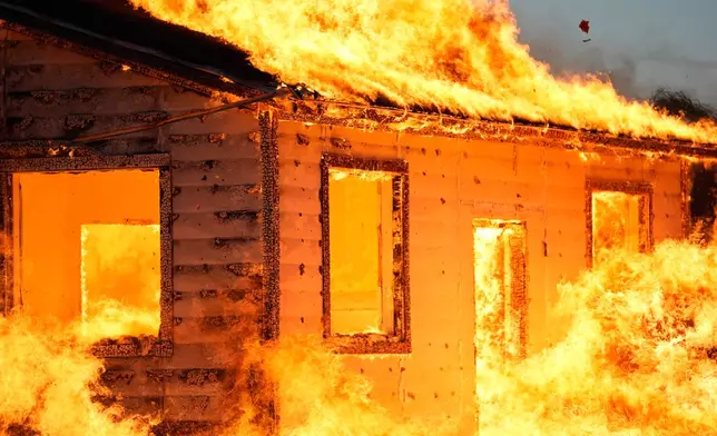 An accessory dwelling unit burns during an experiment at the Institute for Business &amp; Home Safety center on Thursday, April 16, 2026, in Richburg, S.C. (AP Photo/Erik Verduzco)