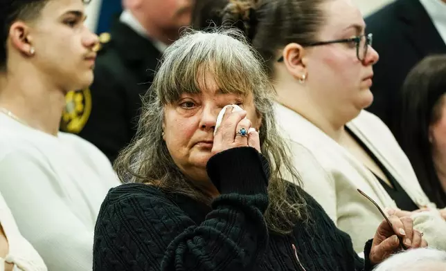 Family members of victims react as they listen Suffolk County District Attorney Raymond A. Tierney during a news conference after Rex Heuermann, accused in Long Island's Gilgo Beach serial killings, pleaded guilty on Wednesday, April 8, 2026, at Suffolk County Police Academy Gymnasium in Brentwood, N.Y. (AP Photo/Eduardo Munoz Alvarez)