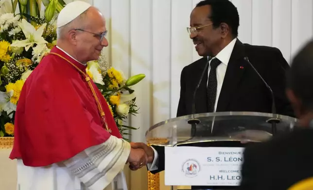 Pope Leo XIV shakes hands with Cameroon's President Paul Biya during the meeting with the authorities, civil society and the diplomatic corps in Yaounde Cameroon, Wednesday, April 15, 2026. (AP Photo/Andrew Medichini)