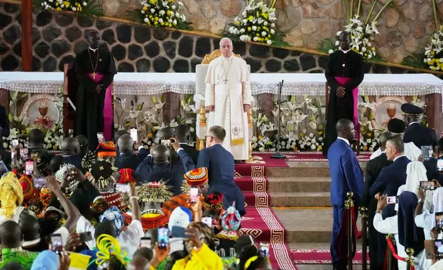 Pope Leo XIV, with the Archbishop of Bamenda Andrew Nkea Fuanya, left, leads a meeting for peace at Saint Joseph's Cathedral in Bamenda, Cameroon, with the local community Thursday, April 16, 2026, on the fourth day of his 11-day pastoral visit to Africa. (AP Photo/Andrew Medichini)