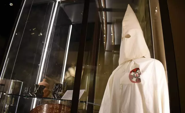 A Ku Klux Klan mask stares out over the Mississippi Museum of History on Friday, March 27, 2026, in Jackson, Miss. (AP Photo/Sophie Bates)