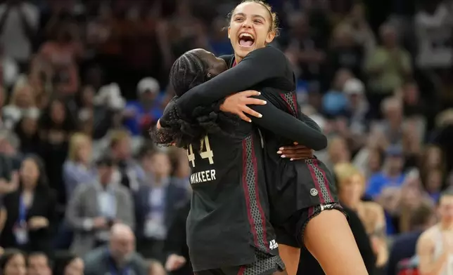 South Carolina guard Tessa Johnson, right, and South Carolina guard Agot Makeer (44) celebrate after defeating UConn in a woman's NCAA college basketball tournament semifinal game at the Final Four, Friday, April 3, 2026, in Phoenix. (AP Photo/Rick Scuteri)