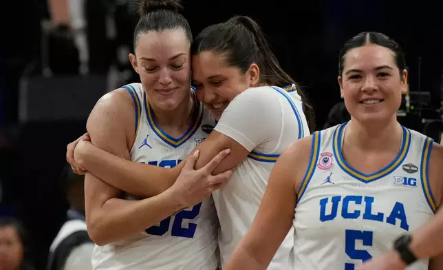 UCLA forward Angela Dugalic, left, and UCLA guard Charlisse Leger-Walker (5) embrace after defeating Texas in a women's NCAA college basketball tournament semifinal game at the Final Four, Friday, April 3, 2026, in Phoenix. (AP Photo/Ross D. Franklin)