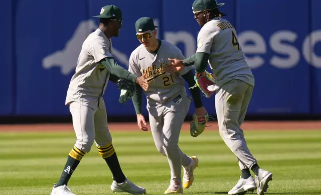 Oakland Athletics outfielders Denzel Clarke, left, Tyler Soderstrom, center, and Lawrence Butler celebrate after a baseball game against the New York Mets, Sunday, April 12, 2026, in New York. (AP Photo/Seth Wenig)