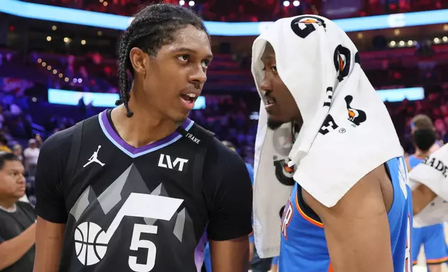 Brothers Utah Jazz forward Cody Williams (5) and Oklahoma City Thunder guard Jalen Williams talk after an NBA basketball game Sunday, April 5, 2026, in Oklahoma City. (AP Photo/Nate Billings)