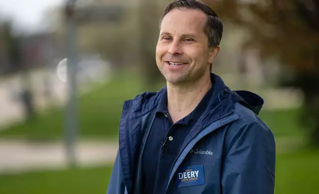 Indiana state Sen. Spencer Deery, R-West Lafayette, who represents District 23, canvasses a neighborhood, Saturday, April 11, 2026, in West Lafayette, Ind. (AP Photo/Doug McSchooler)