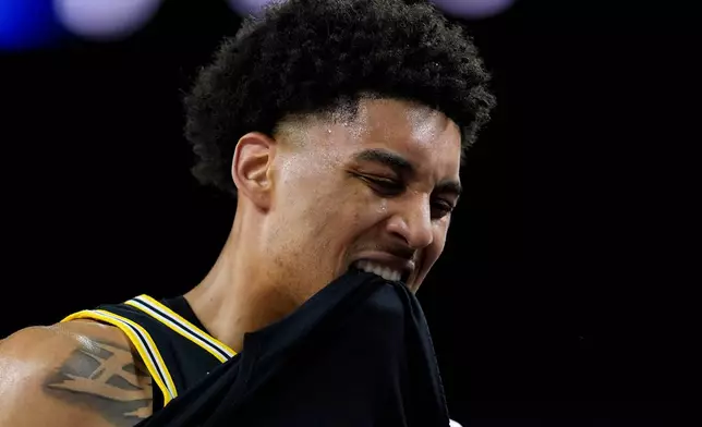 Michigan forward Yaxel Lendeborg reacts after an injury on the court during the first half of an NCAA college basketball tournament semifinal game against Arizona at the Final Four, Saturday, April 4, 2026, in Indianapolis. (AP Photo/Abbie Parr)