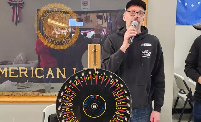 Volunteer John Sartwell announces the winning numbers during a meat raffle April 10, 2026, at American Legion Post 150 in Waconia, Minn. (AP Photo/Steve Karnowski)