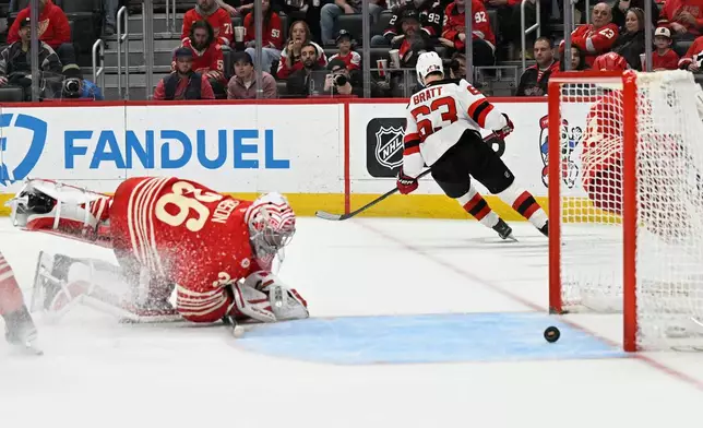 New Jersey Devils left wing Jesper Bratt (63) skates away after scoring past Detroit Red Wings goaltender John Gibson, left, during the third period of an NHL hockey game, Saturday, April 11, 2026, in Detroit. (AP Photo/Jose Juarez)