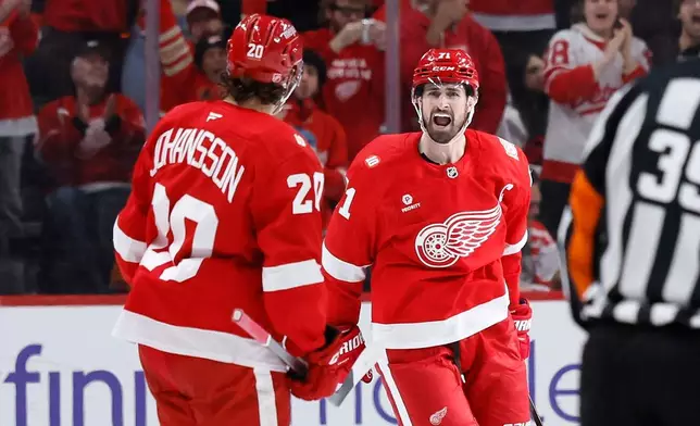 Detroit Red Wings center Dylan Larkin (71) shouts out as he celebrates his goal against the Philadelphia Flyers with defenseman Albert Johansson (20) during the second period of an NHL hockey game Thursday, April 9, 2026, in Detroit. (AP Photo/Duane Burleson)