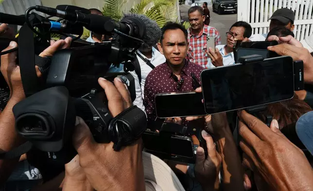 Am Sam Ath, center, monitoring manager of LICADHO, a human rights organization, speaks to journalists after a court session of former Cambodia National Rescue Party's President Kem Sokha outside an appeals court in Phnom Penh, Cambodia, Thursday, April 30, 2026. (AP Photo/Heng Sinith)