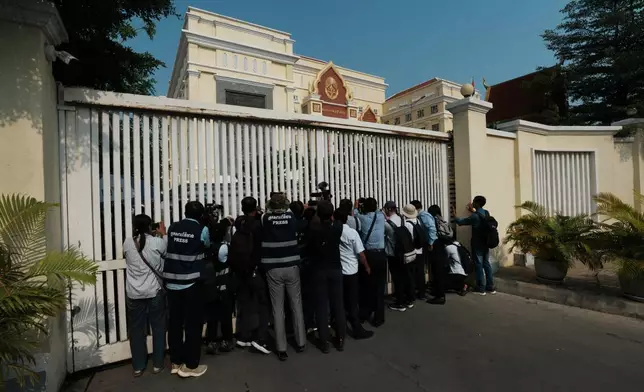 Journalists photograph after a court session of former Cambodia National Rescue Party's President Kem Sokha outside an appeals court in Phnom Penh, Cambodia, Thursday, April 30, 2026. (AP Photo/Heng Sinith)